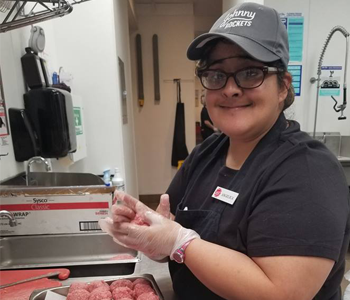 Anthesis participant working in her dream job at Johnny Rockets.